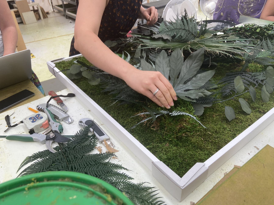 Jungle moss picture with fatsia leaf, fern and eucalyptus being made