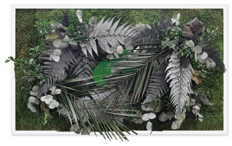 Plant picture with preserved ferns and palm leaves in silver and deep green on moss